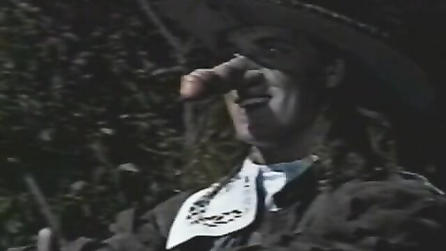 Vintage cowboy actor sniffing finger closeup in classic erotic flick