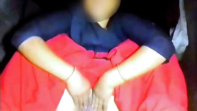 Busty Indian babe in red skirt and blue top sits with legs spread