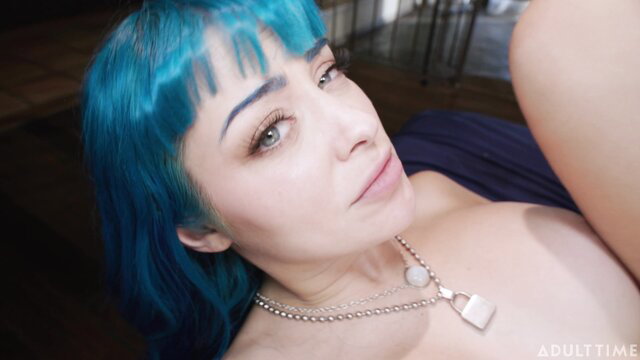 Turquoise-haired beauty with chain necklace in seductive pose