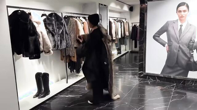 Pam shopping fur coats in luxury boutique, chic style