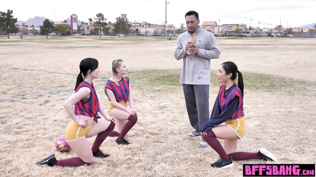 Avery Black and Asian teen footballer BFFs in shorts kneeling for coach
