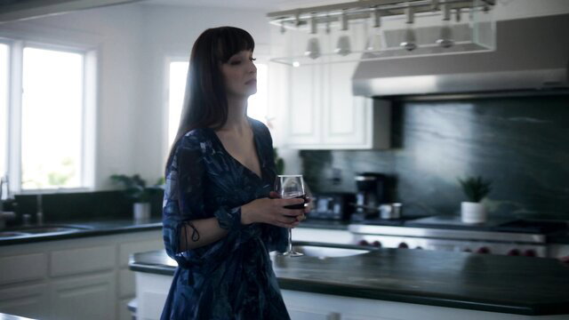 Lexi Luna sexy MILF in dress holding wine glass in kitchen