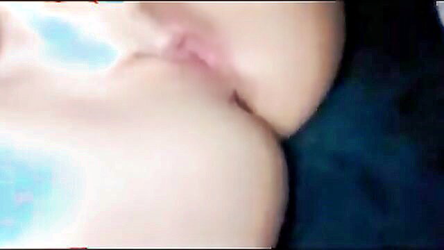 Closeup of woman masturbating with blue toy on pale tits lips