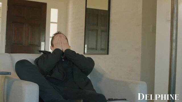 Delphine Films: Man covering face in shame on couch in Dad's Security Guard scene