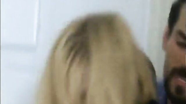 Blonde woman kneels for bearded man's cock in intense closeup