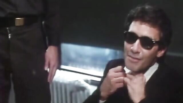 Vintage 1983 smoker John Holmes in suit sunglasses classic porn thumbnail