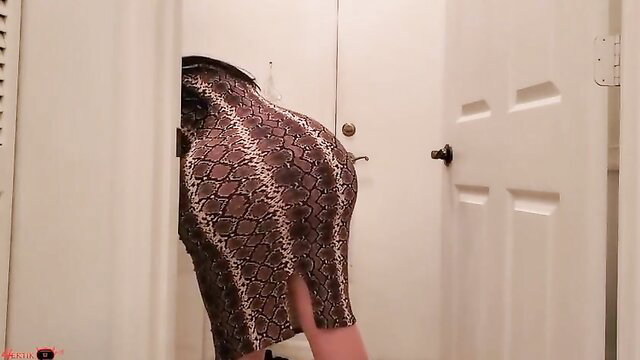 Horny MILF massive booty in snakeskin dress bent over in laundry room