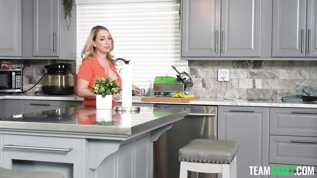Blonde babe in orange dress in modern kitchen FFM preview