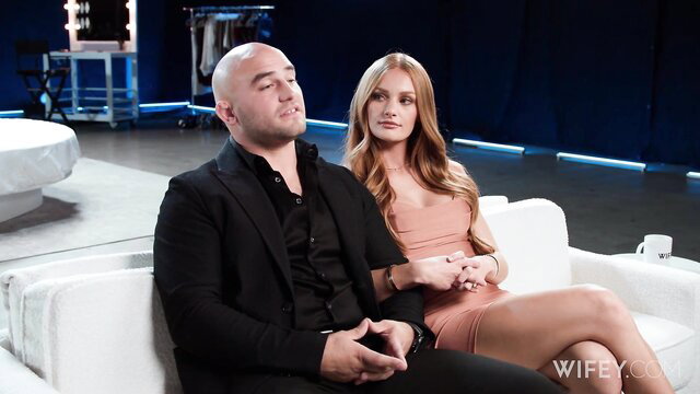 Jessi Rae in pink dress with Jason Luv on Wifey couch interview
