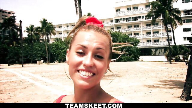 Flexible blonde swimsuit babe smiling on sunny beach