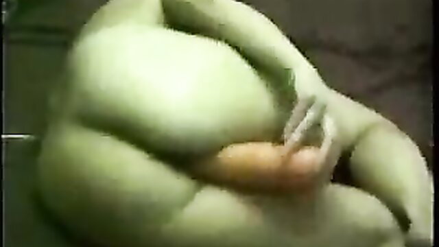 Wife's green body grips huge orange dildo in solo toy play
