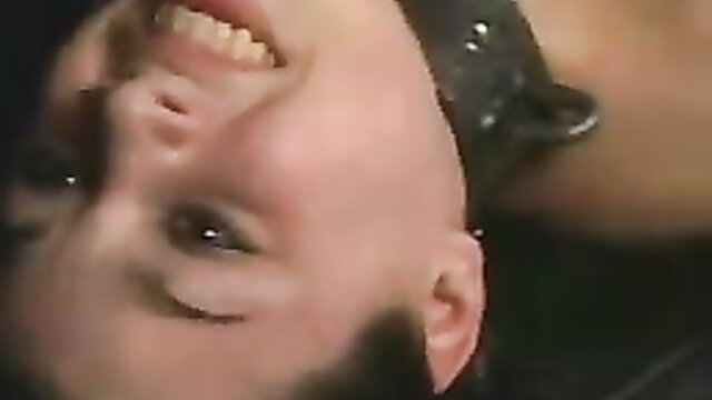 Baby-faced teen smiling upside down in brutal torture scene