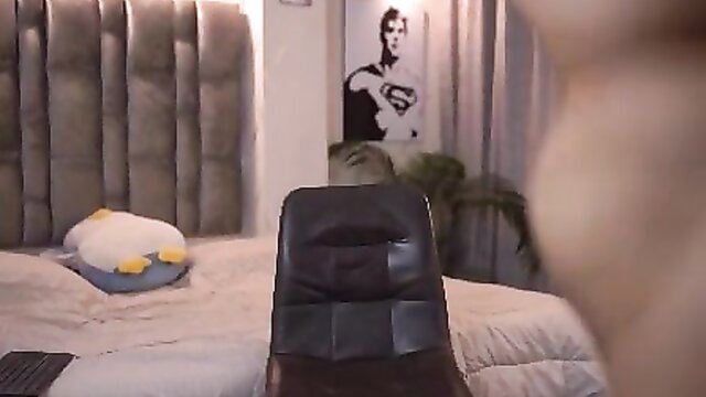 Luxury bedroom POV with white duck pillow and Superman poster