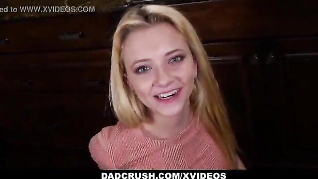 Cute blonde stepdaughter smiles in tight pink top, relieving stress