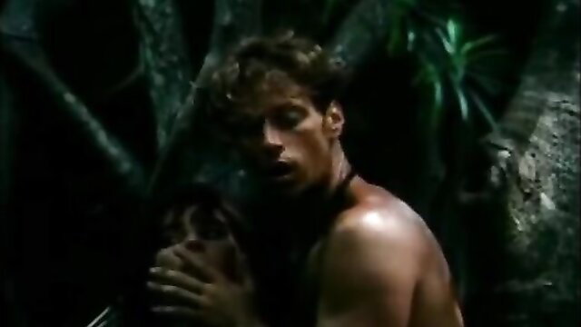 Rocco Siffredi bare-chested embracing woman in jungle, Shame of Jane