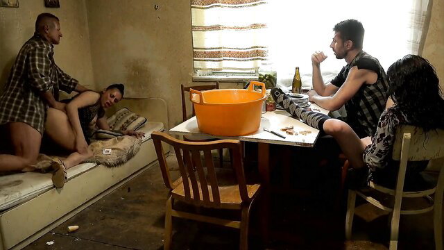 Twisted family gangbang: woman fucked on couch by men at table