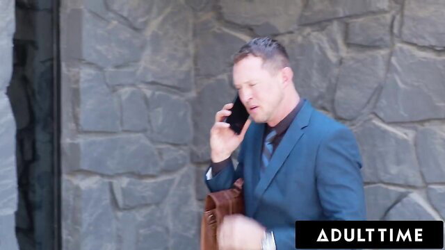 Vanessa Vega's lawyer on phone in suit against stone wall AdultTime