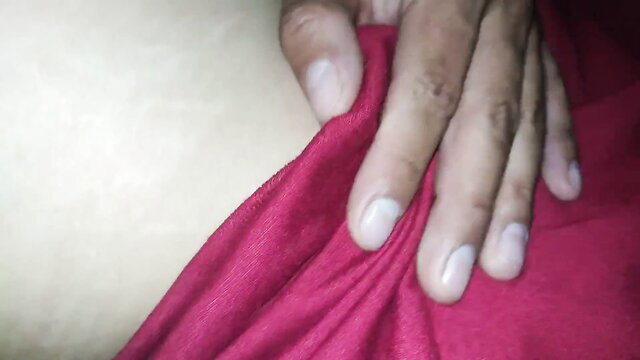 Amateur hand gripping red dress on pale skin closeup