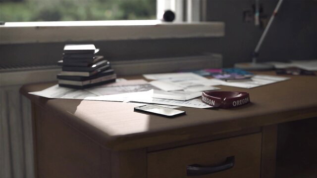 Rachel Amber inspired desk scene with papers, VHS tapes, Oregon wristband
