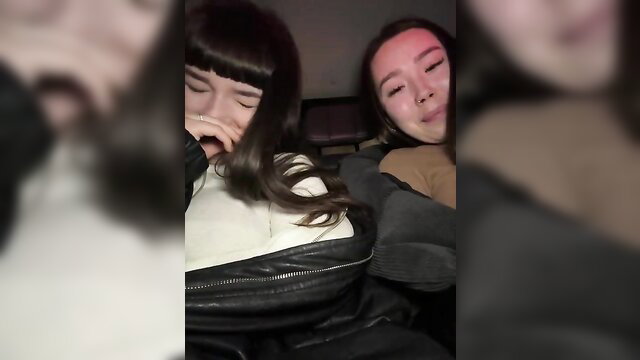 Two cute Asian teen girls cuddling asleep, one fingering mouth seductively