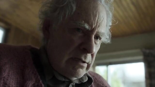 Elderly white man with gray hair frowning in dimly lit room - Disclaimer s01e01-02