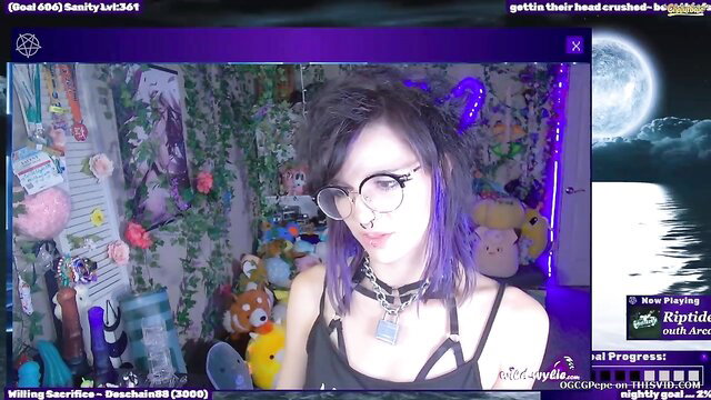 Alt goth camgirl with purple hair and glasses in bedroom stream