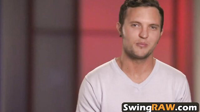 Handsome man in white V-neck on swinger bondage reality show