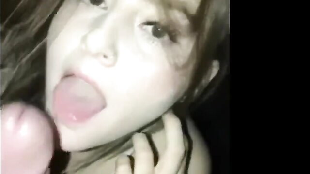 Asian girl with tongue out licking pink dildo in closeup throat POV