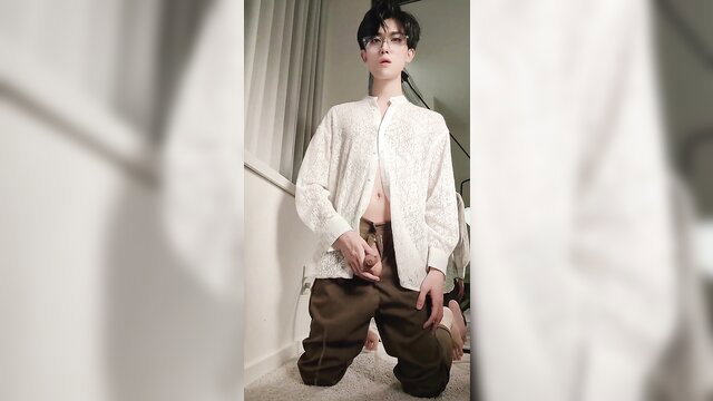 ShyboyInker kneels in open white shirt and pants, teasing shaft bulge