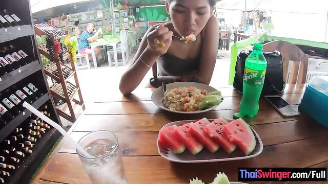 Thai teen tiny body eating at outdoor market in tight top