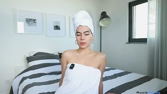 Latina woman with towel turban, nude shoulders in bedroom tease