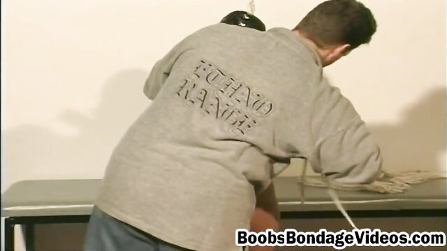Man roughly ties up hot babe in Boobs Bondage Videos scene