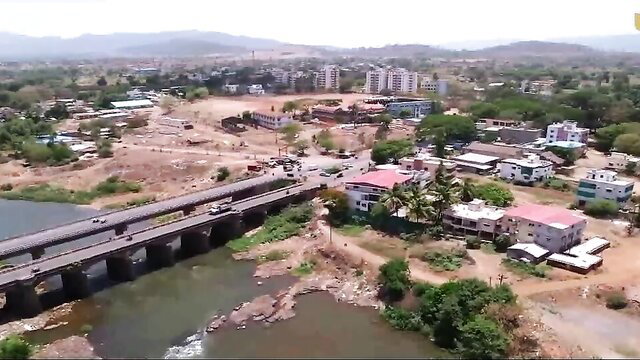 Aerial drone view of rural bridge over river and village in Garam Masala Ullu series