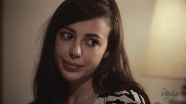 MissaX teaser: sultry brunette in striped top gazes seductively