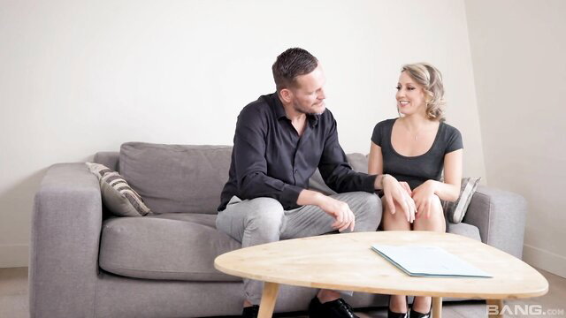 Emmanuelle Worley chats intimately on sofa with stud in tight top