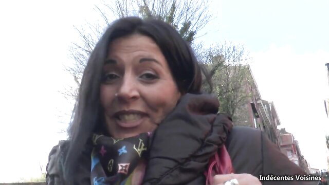Hot brunette MILF in scarf and coat smiling outdoors amateur tease