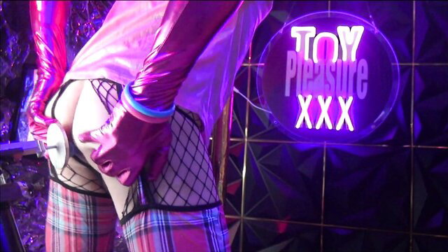 Sissy in pink latex spreading fishnet ass at Toy Pleasure XXX club