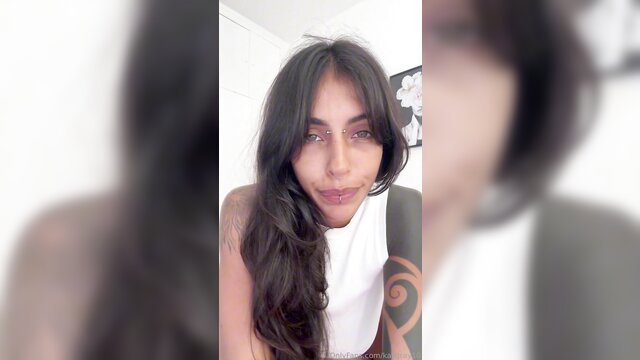 KaliGray10 closeup smiling with tattoos in white top