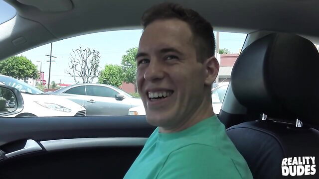 Hot guy Alex in car smiling, showing off body for Reality Dudes cash