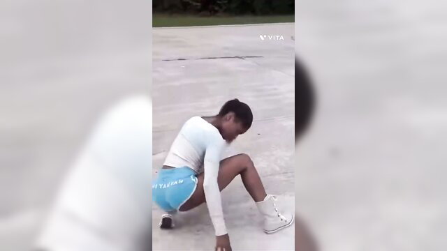 Petite black babe in tight shorts twerking big ass on concrete