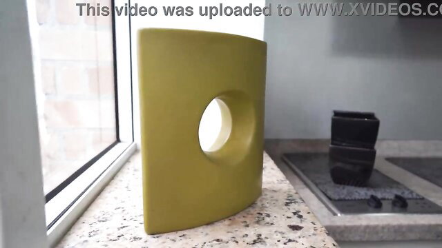green object with a hole on a kitchen counter