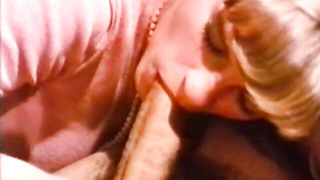 Blonde woman deepthroating cock in classic orgy club scene