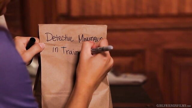 Blonde lesbian writing seductive note on bag in steamy girl-on-girl scene