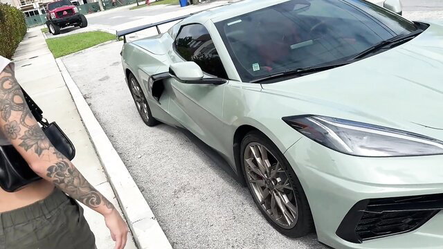 Tattooed Charlotte Mae poses by Corvette in skimpy top before POV anal
