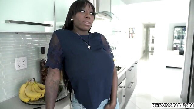 Ebony Mystique in sheer top, posing sexy in kitchen with bananas