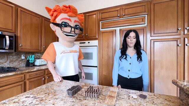 Serena Sterling in kitchen with orange mascot, big tits black hair babe