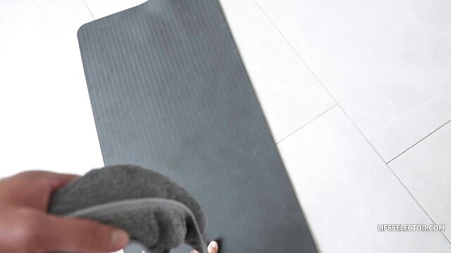 Kriss Kiss cleaning yoga mat with wet rag in tight top, hot tease