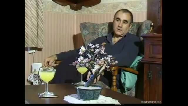 Old man relaxes in chair with bonsai and cocktails in mature gangbang scene