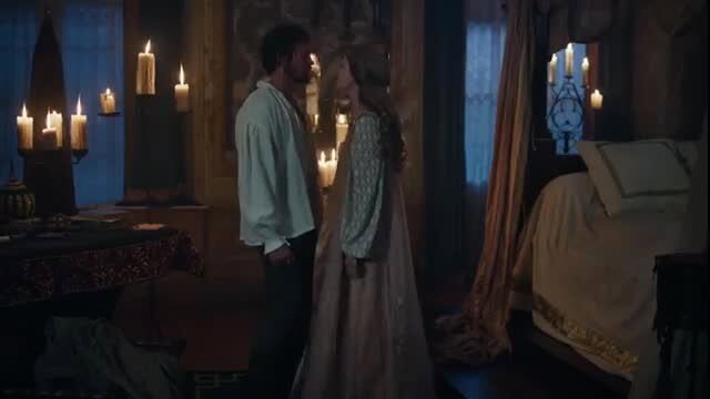 Greta Ferro and Sai Bennett in candlelit bedroom romance, El Turco nude scene