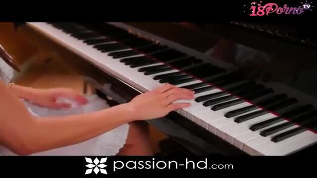 Teal Conrad playing piano in sexy white dress, nude shoulders